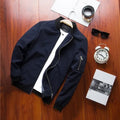 Men's slim-fit red casual baseball jacket with front zipper and side pockets.