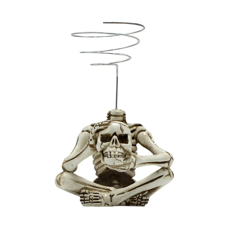 Grey resin skull plant bracket with iron base for displaying Tillandsia air plants