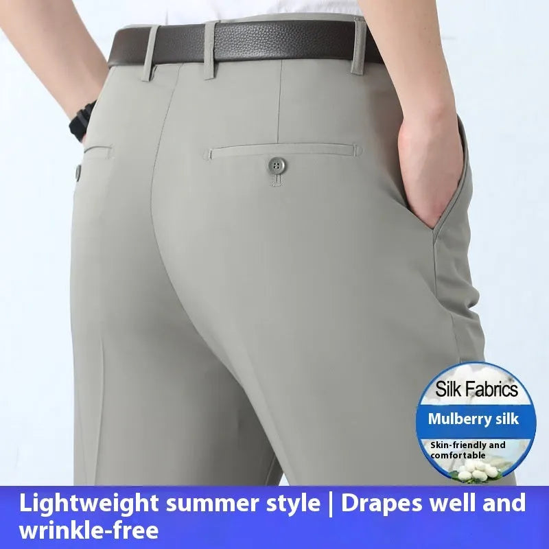 Man wearing black straight-leg high-waisted non-iron business trousers made from a Mulberry Silk blend fabric.