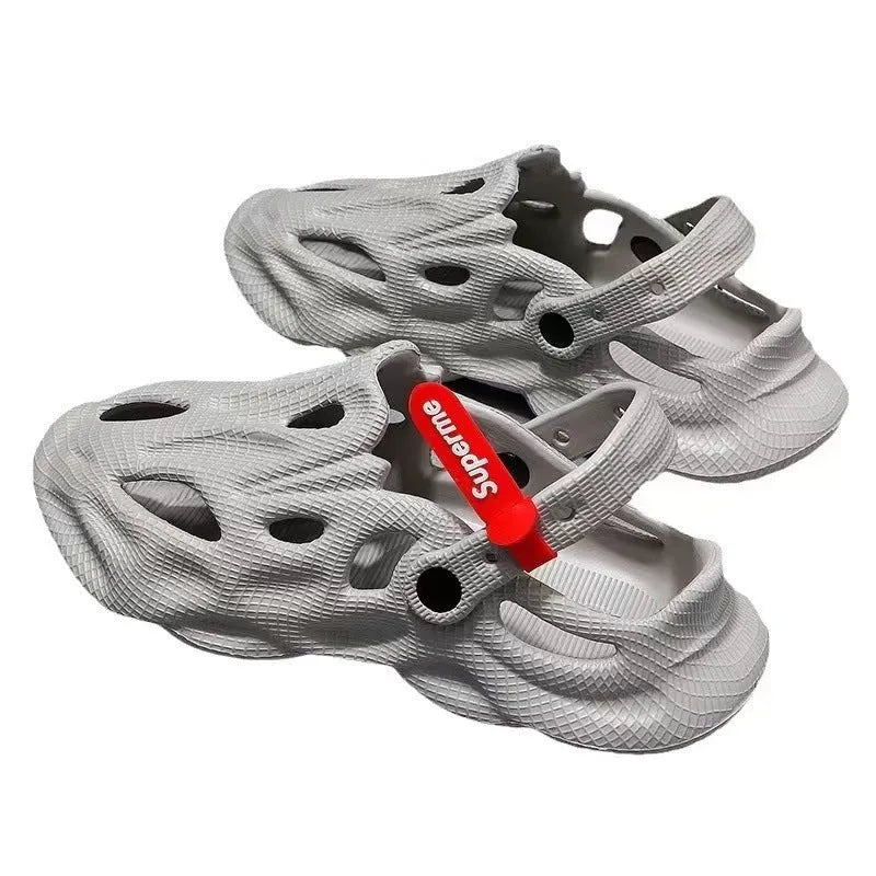 Men's grey coconut slippers with closed toe design and EVA construction on wooden deck