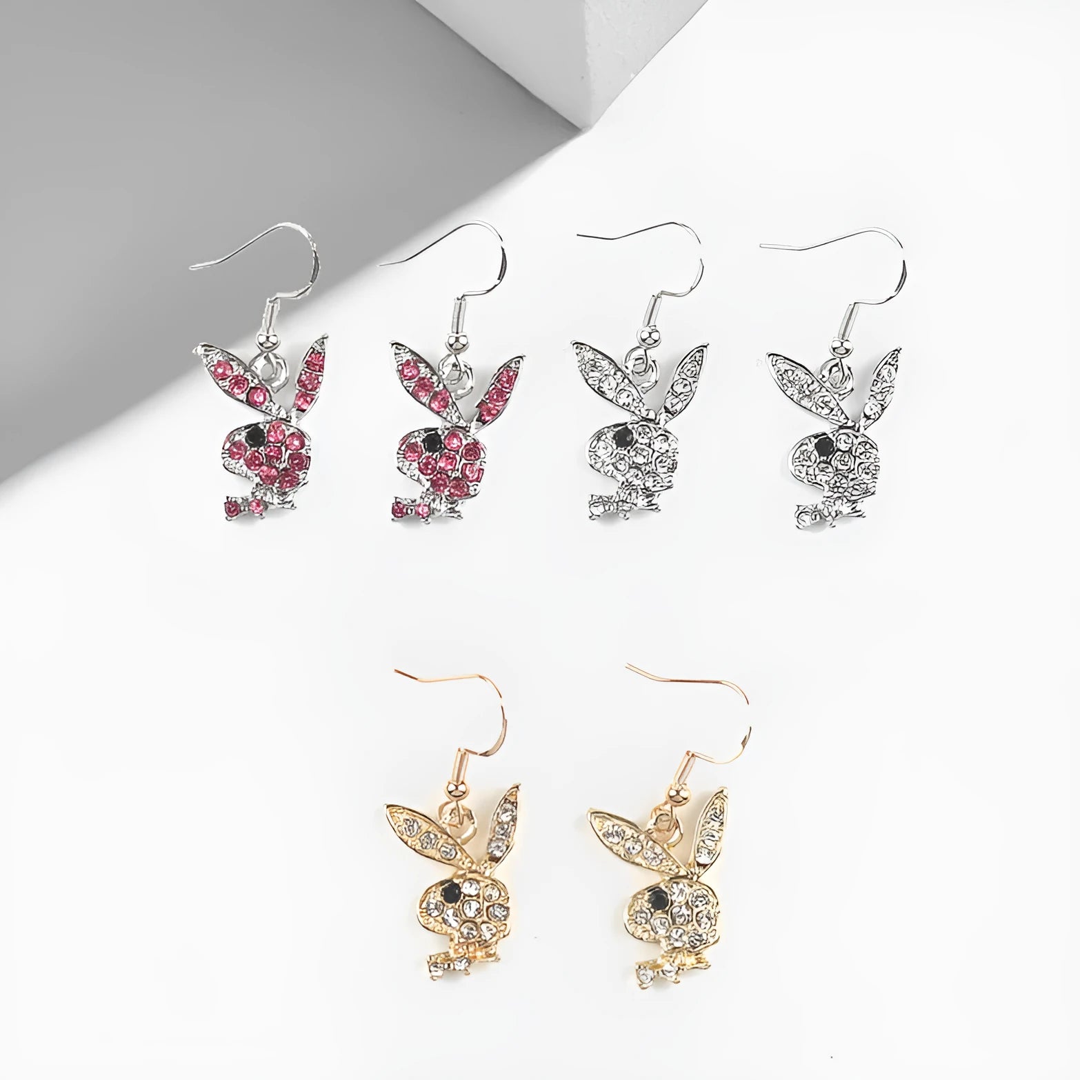 Rabbit stud earrings with diamond-cut surface detail in gold, pink and silver metallic finishes
