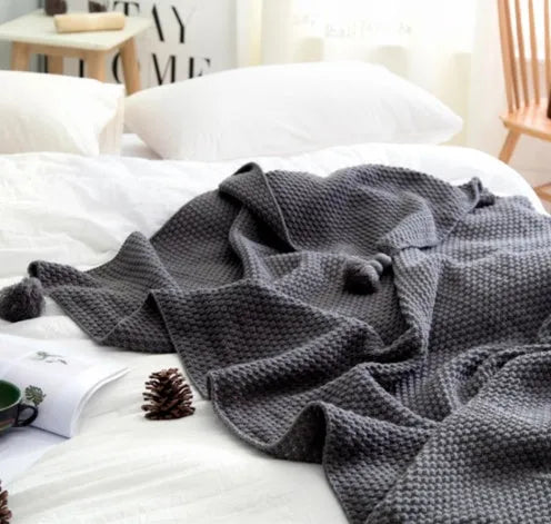 Nordic fringed knit ball acrylic blanket in beige colour showing texture detail and 130x170cm size