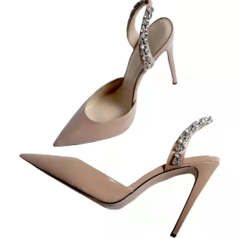 Women's pointed toe high heel sandals with rhinestone detail on patent leather upper.