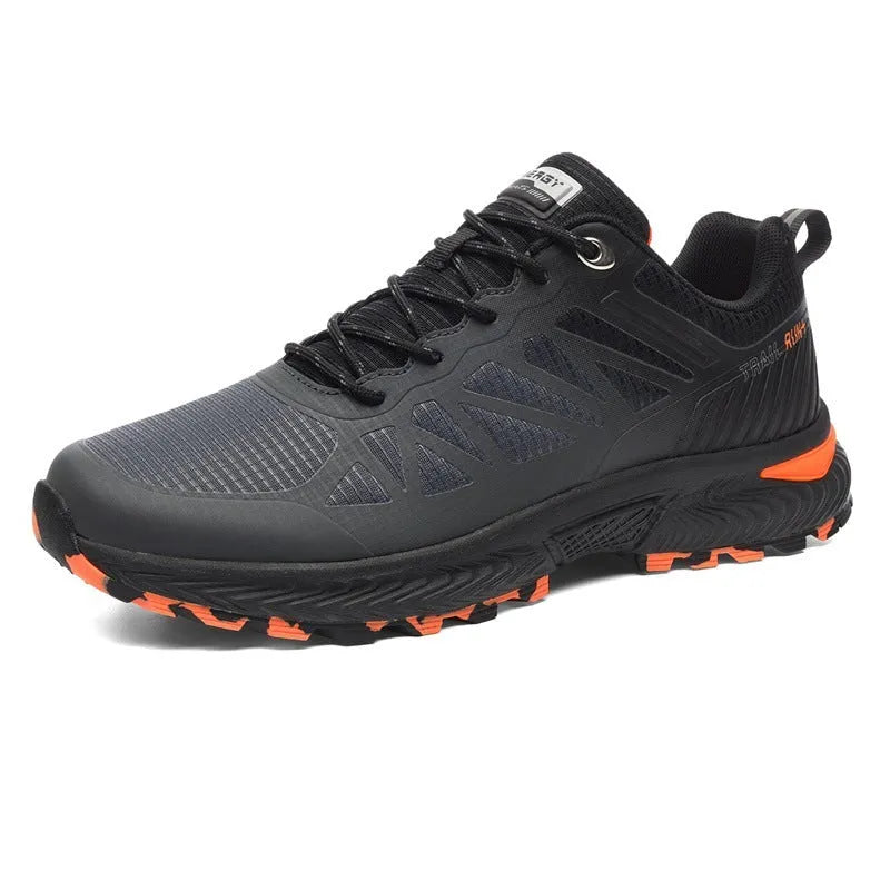 Men's black and orange mesh running shoe with lace-up front and rubber sole.