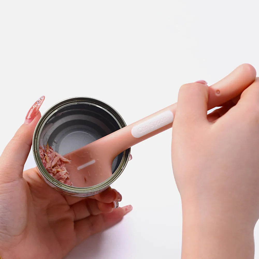 Green long-handle pet feeding spoon for canned cat and dog food on a white background.