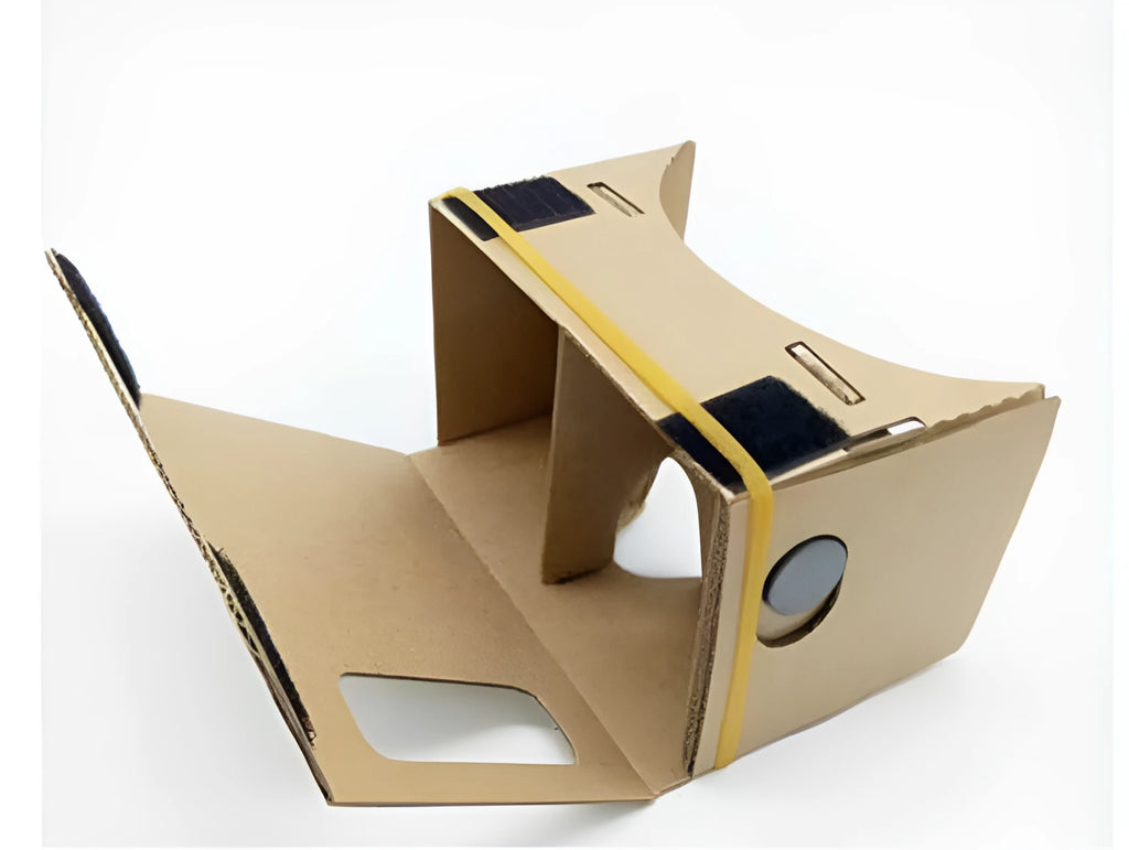 Pink and white cardboard VR headset for smartphones with adjustable strap and magnetic button.