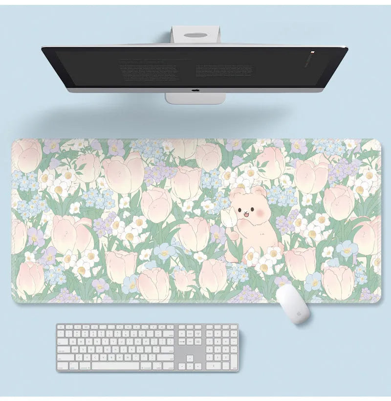 Large flower pattern mouse pad on a desk with keyboard, showing non-slip rubber base and colourful tulip design.