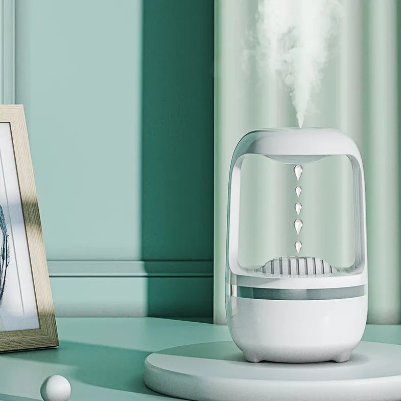 Black anti-gravity humidifier showing water droplet backflow effect with USB cable