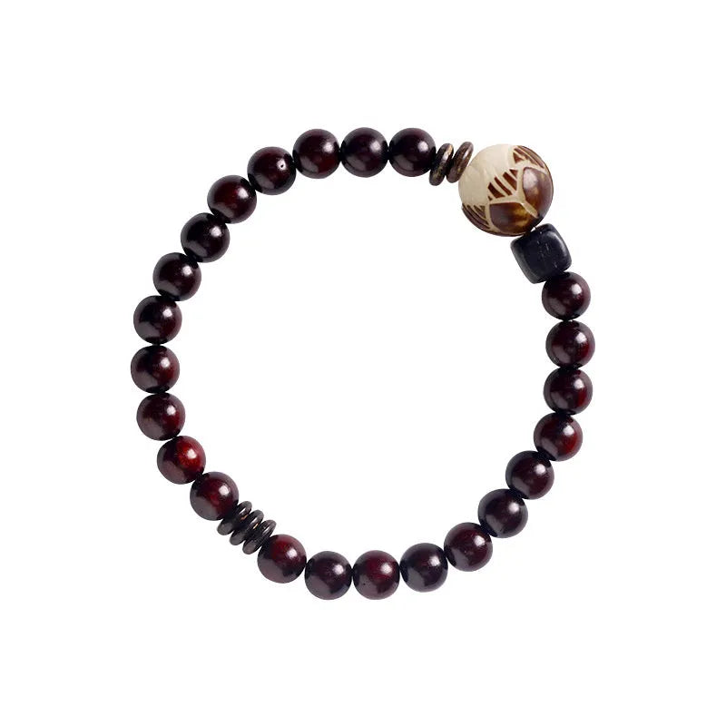 Rosewood bracelet with floral bead and knitted construction showing natural wood texture