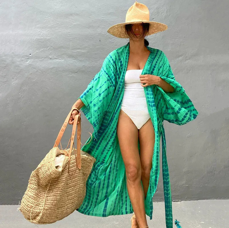 Loose-fitting cotton beach cover-up blouse in a printed pattern, shown in a rust red colour.