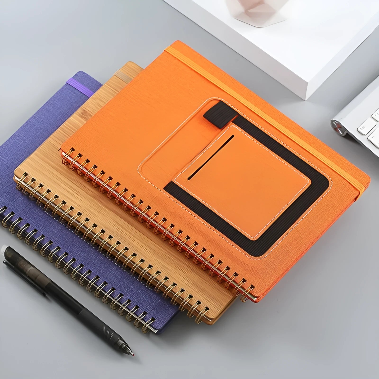 A5 erasable coil notebook with stone paper and pen on wooden surface