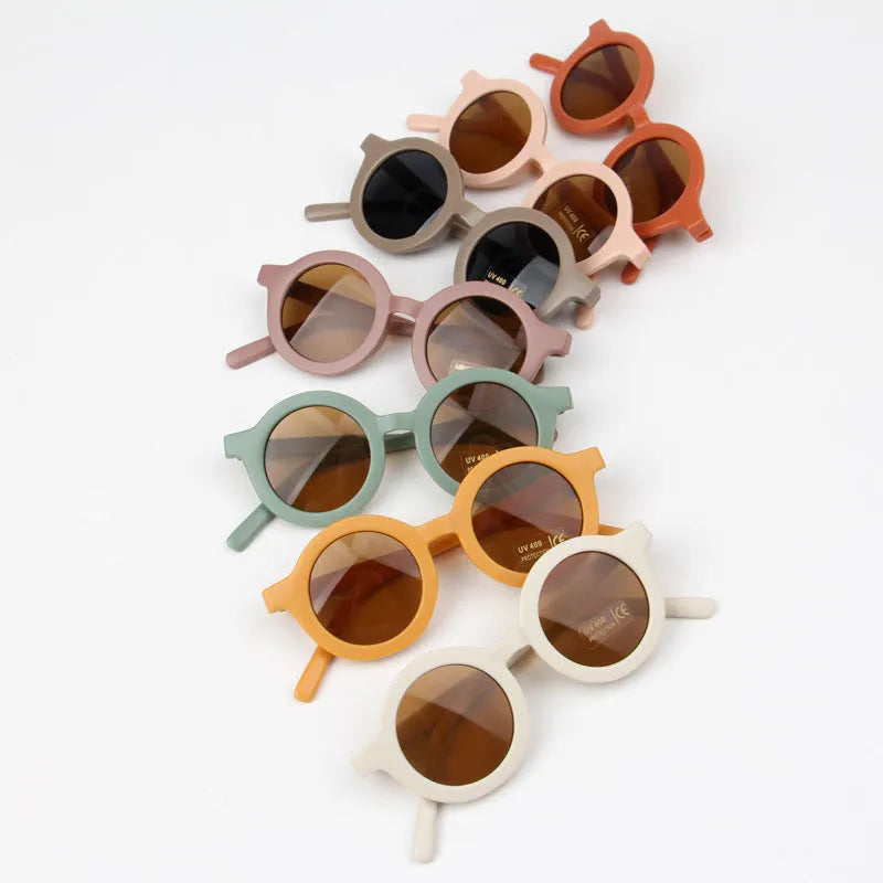 Children round frame retro mocha glasses on a child, showing the PC frame and resin lenses available in Beige, Brown, Green, Orange Red, Orange Yellow, Pink, and Purple colours
