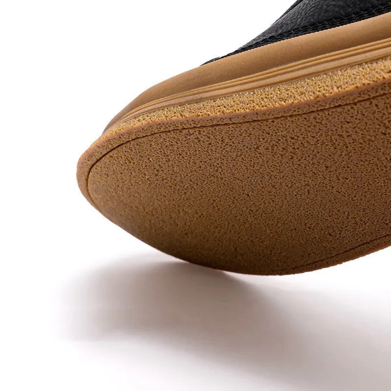 Men's black leather casual shoes with white stitching and lace closure on a white rubber sole
