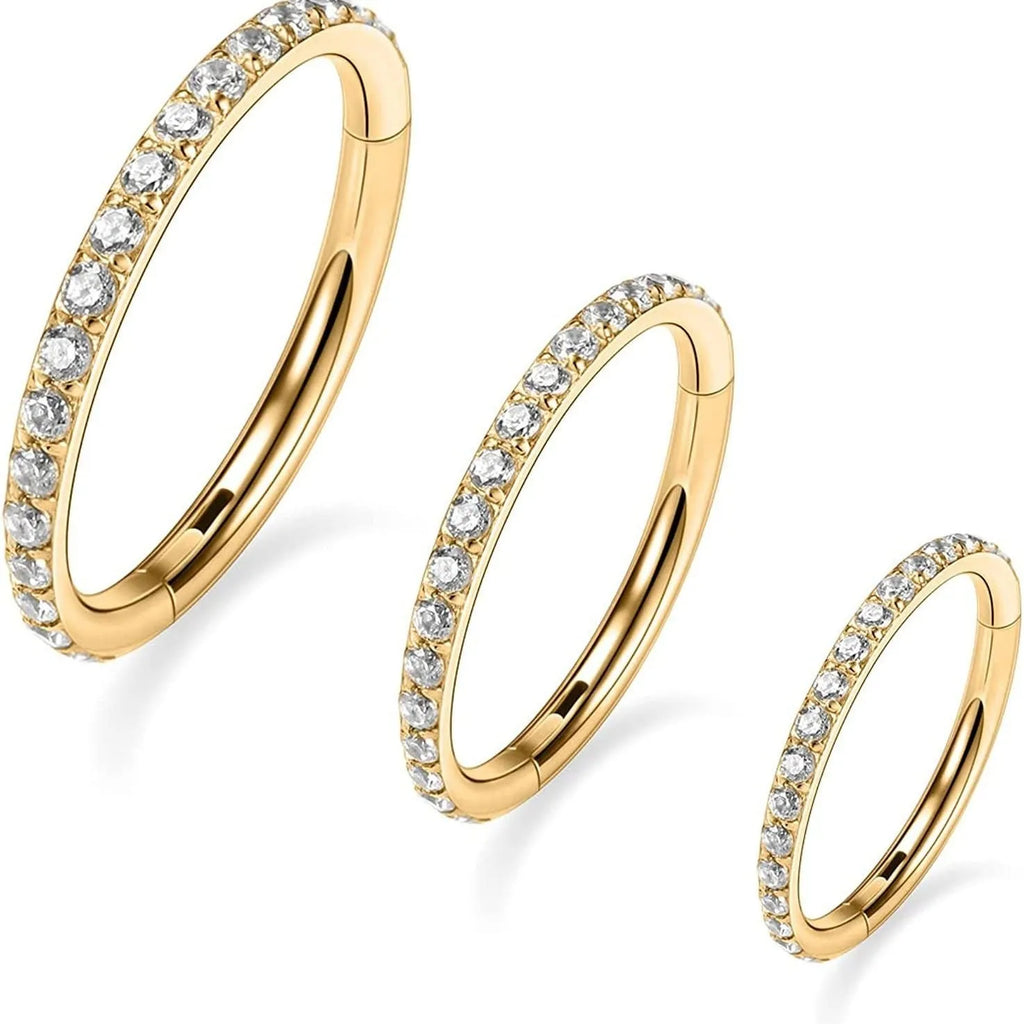 A round stainless steel seamless nose ring shown in gold, rose gold, black, and steel colour finishes.