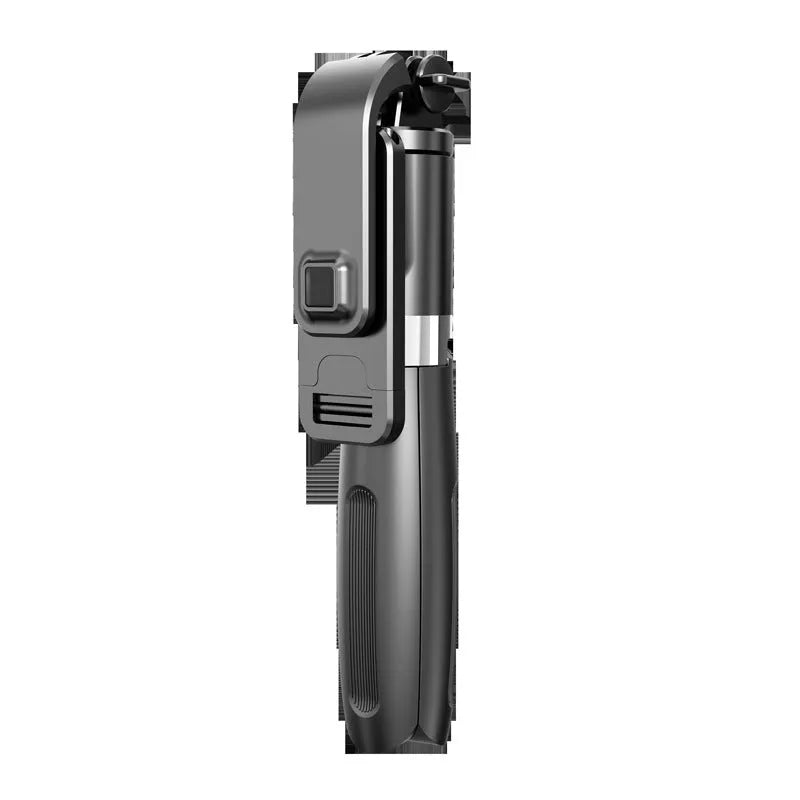 Black and white Bluetooth selfie stick with wireless remote, extended on a tripod base next to a smartphone.