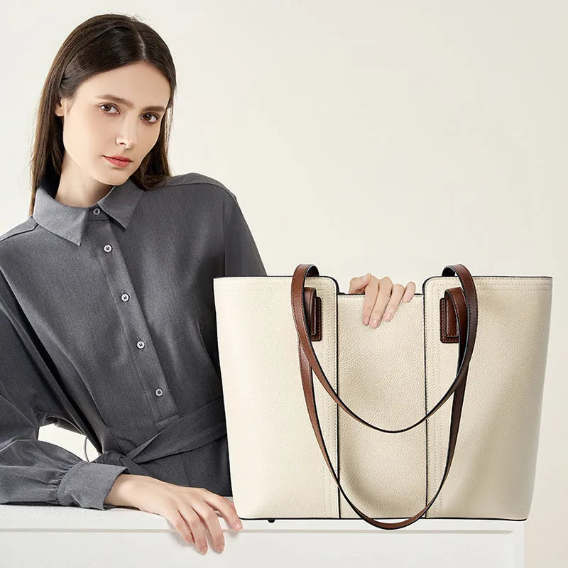 Women's black horizontal square leather commuter shoulder bag with crossbody strap and internal organiser pockets.