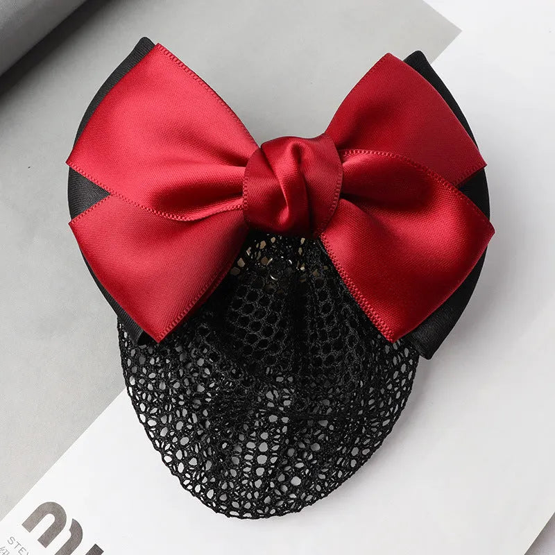 Professional flower bow headdress hair clip ornament on a work plate, shown in a selection of net and mesh colour variations.