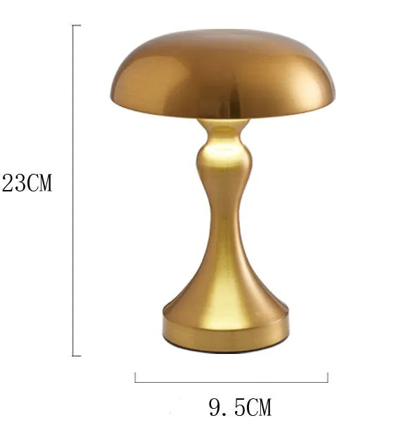 Metallic rechargeable touch desk lamp showing bronze, gold, and silver colour options on a wooden desk.