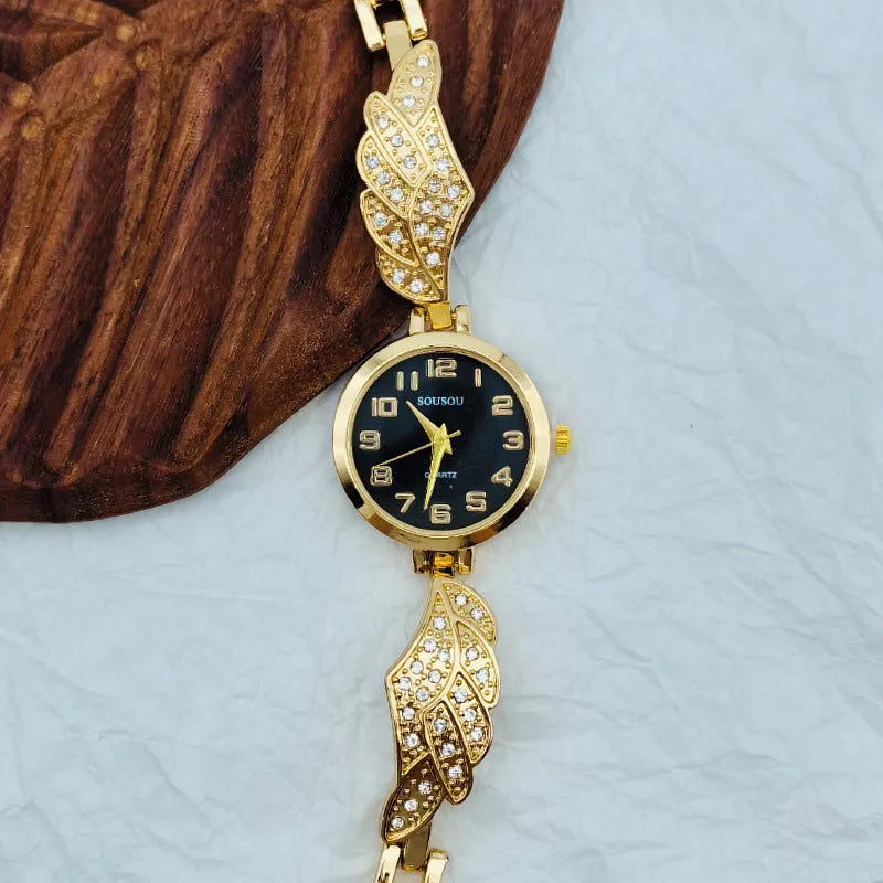 Stainless steel women's watch with round dial on wrist, showing gold surface finish option.