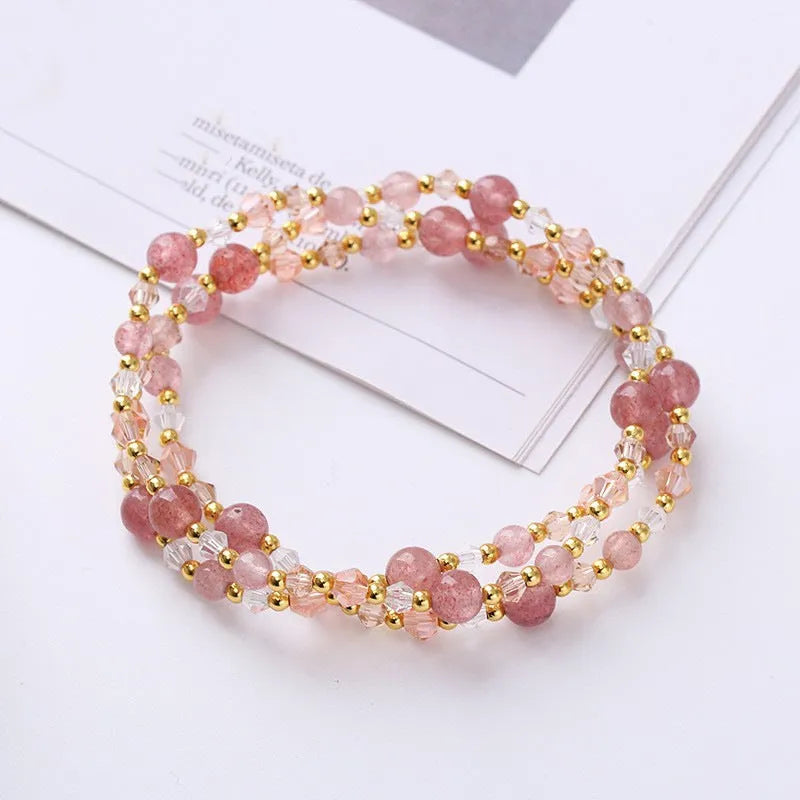 Three-ring crystal bracelet with tourmaline, strawberry quartz and amethyst stones on adjustable tightening rope