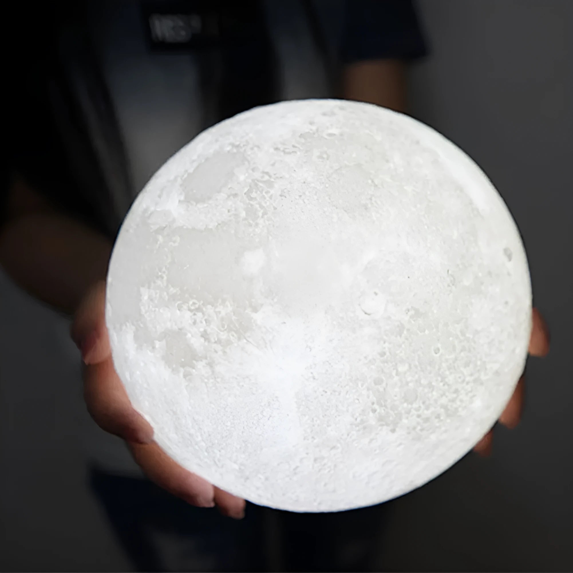 3D printed spherical moon lamp on a wooden stand with touch ring control
