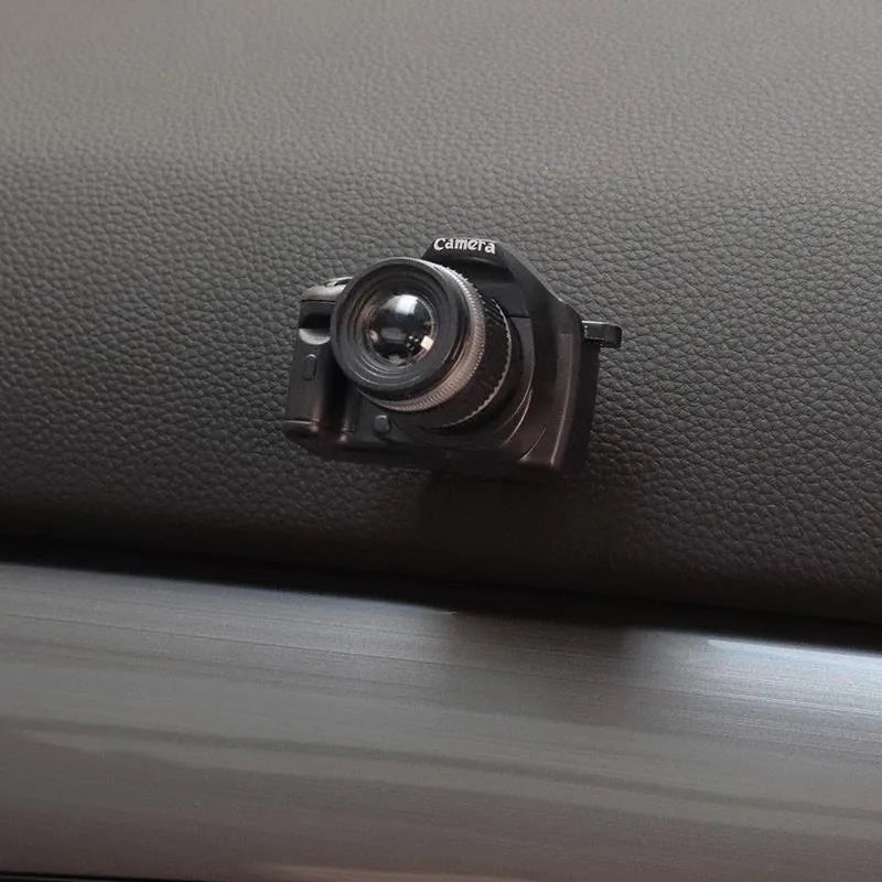 Set of four retro camera dot design plastic adhesive hooks for car dashboard organisation.