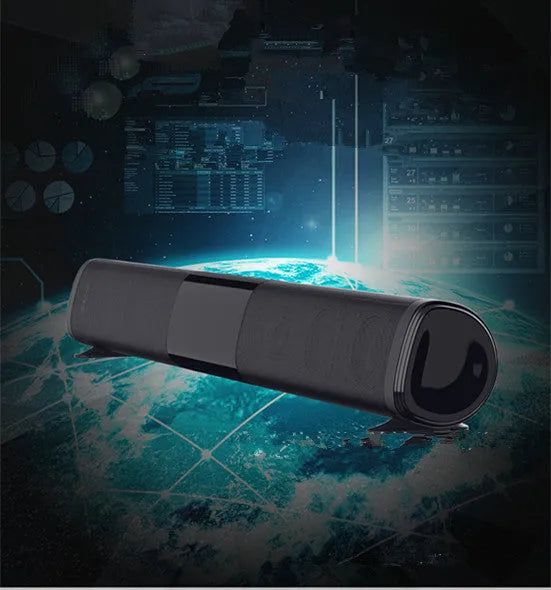 Tall black Bluetooth sound bar speaker with remote control on a wooden surface