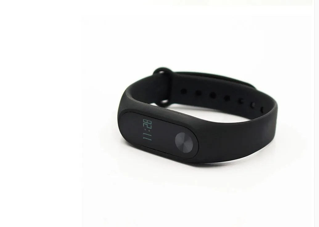 Xiaomi Mi Band 2 black fitness tracker with OLED screen on a grey wrist strap.