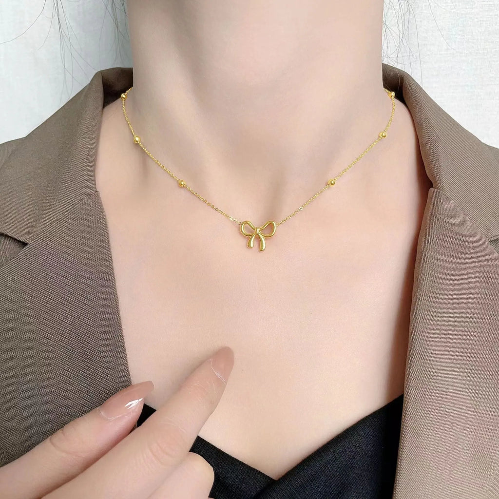 Gold bow necklace with cross chain links and adjustable 41-50cm length