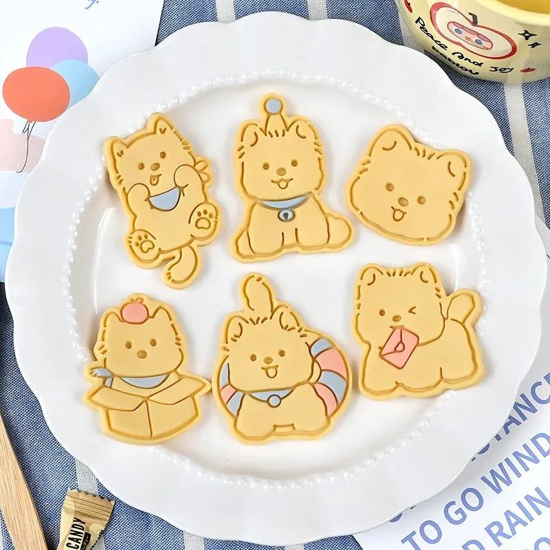 Three dimensional plastic biscuit mold showing puppy head and birthday hat designs