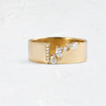 Gold-coloured copper ring with a shining zircon stone on a model's hand.