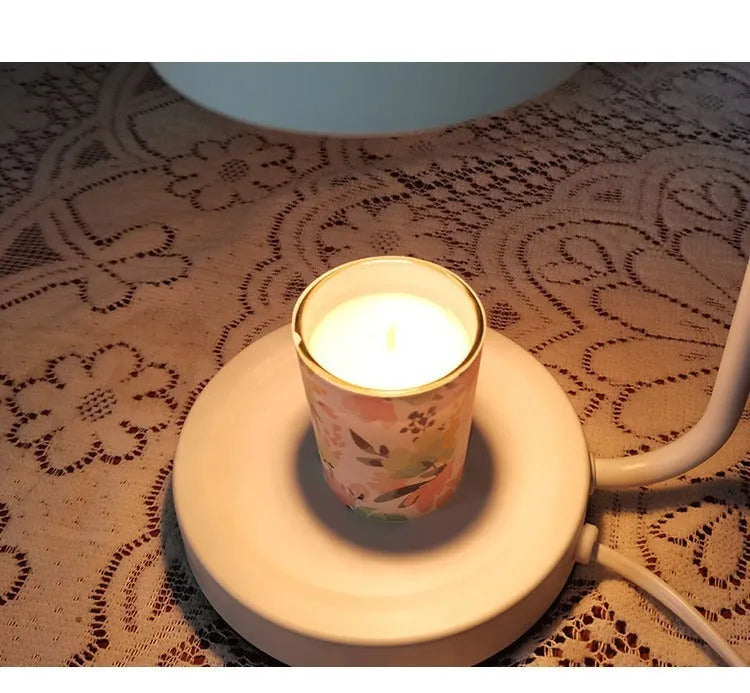 European-style white metal aromatherapy wax melting lamp with dimmer switch on table.