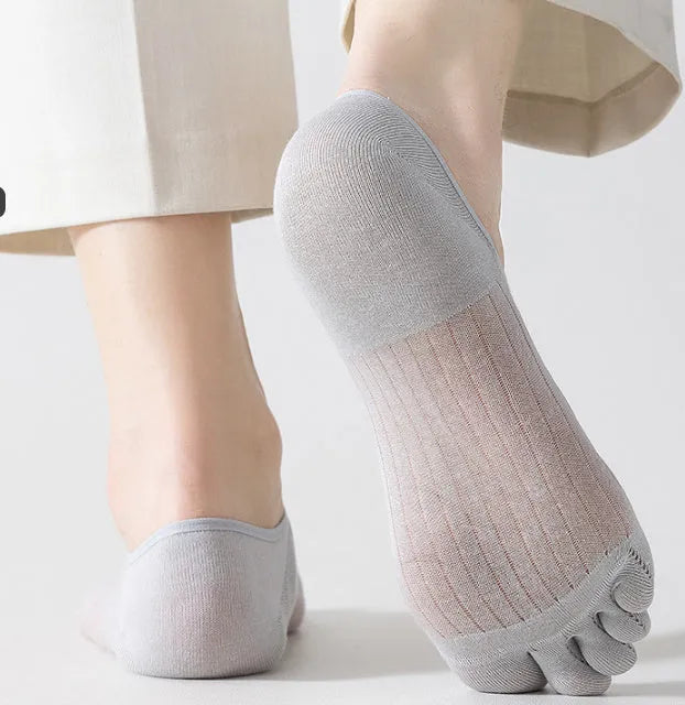 Pair of solid colour modal five-finger boat socks laid flat.