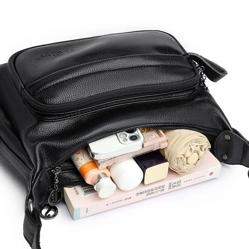 Large black PU shoulder bag with crossbody strap showing multiple internal compartments and zipper closure