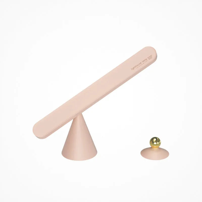 Geometric desk lamp with magnetic base shown attached to metal surface as wall light