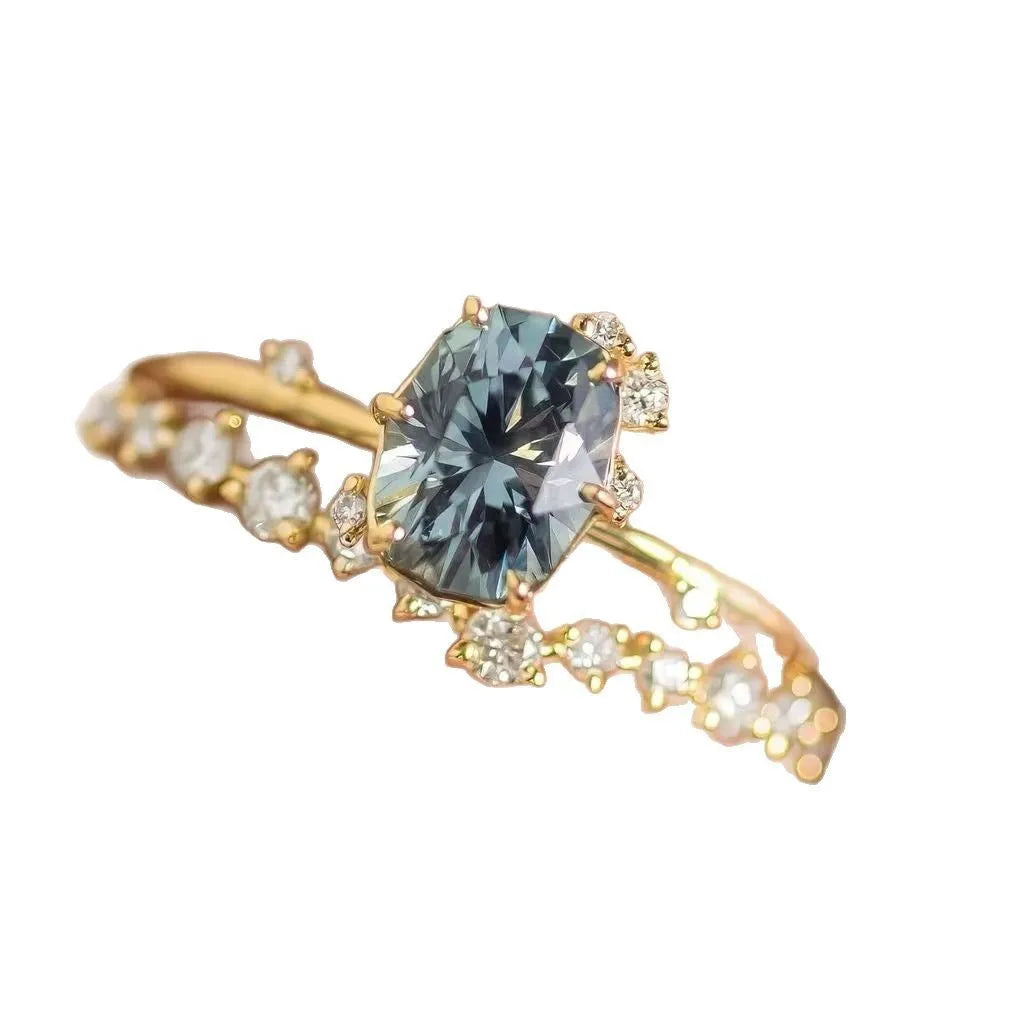 Gold plated floral pattern ring with green zircon stone inlay on woman's finger