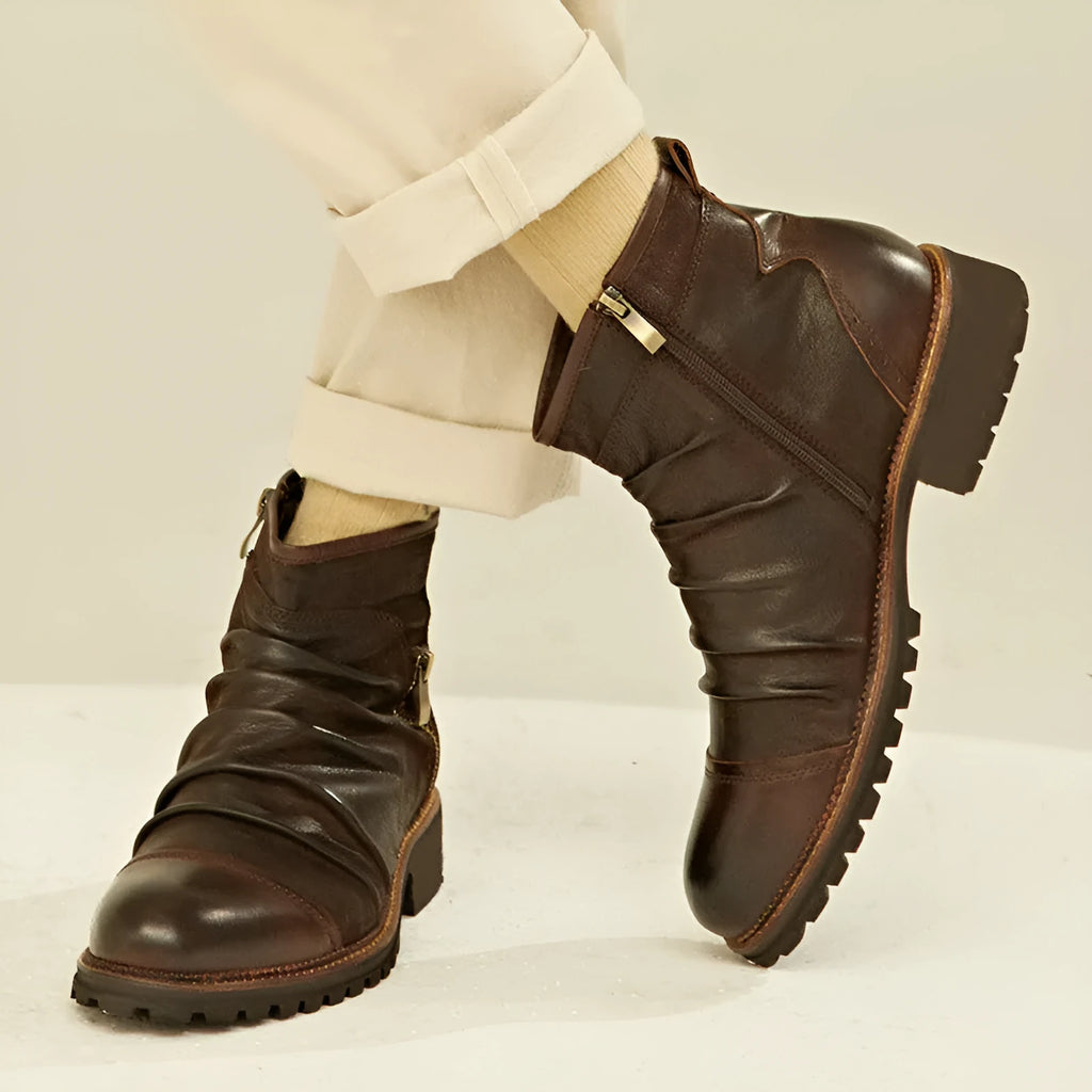 Black and brown mid-calf cowboy boots with a side zipper, round toe, and horseshoe heel