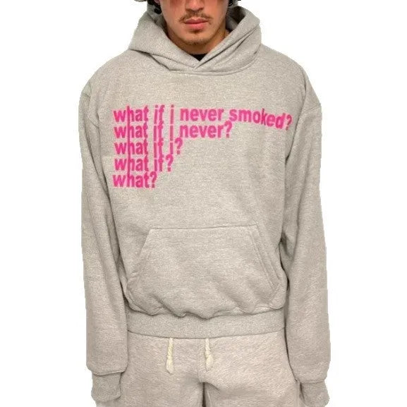 Man wearing a black heavyweight hooded sweater with a large white letter print design on the front.