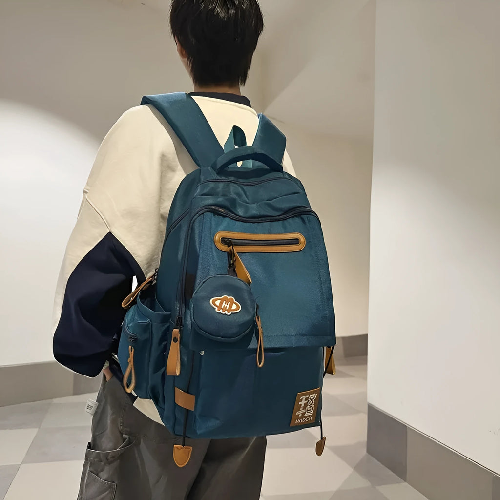 Large black nylon backpack for school with curved shoulder straps and sewing line detail