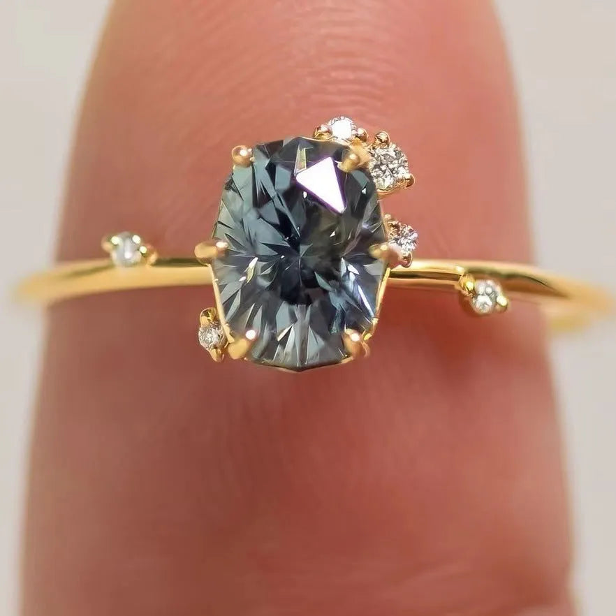 Gold plated floral pattern ring with green zircon stone inlay on woman's finger