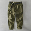 Men's loose-fit cotton overalls in army green colour, showing casual Japanese style and mid-waist design.