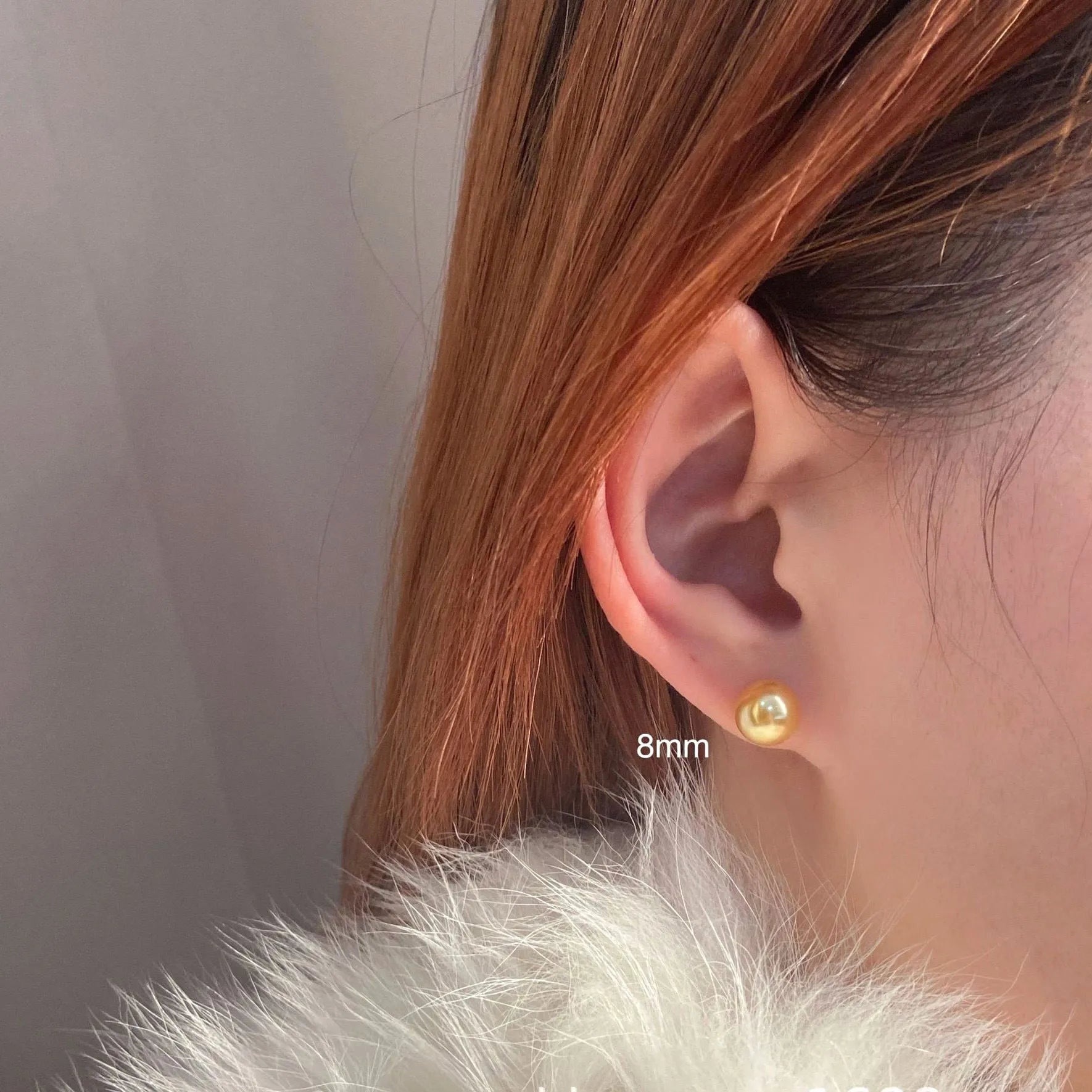 A pair of large geometric pearl stud earrings with an eight-point star detail on silver settings.