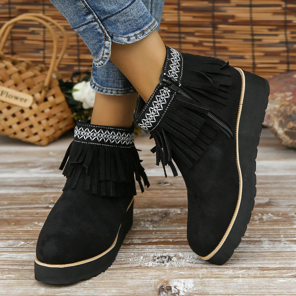 Womens dark brown suede wedge ankle boots with side zip and tassel detail on a thick rubber sole.