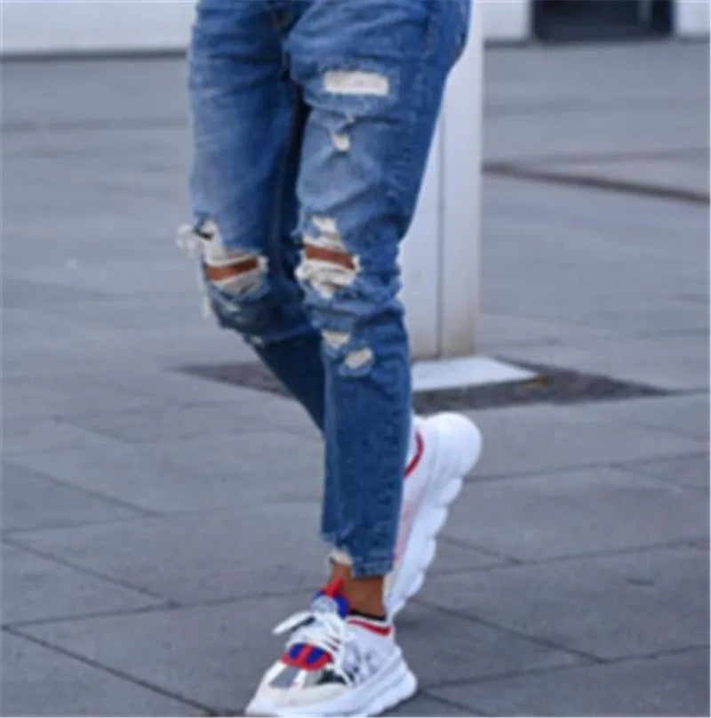 Men's deep blue cotton jeans laid flat, showing front detail and classic five-pocket design.