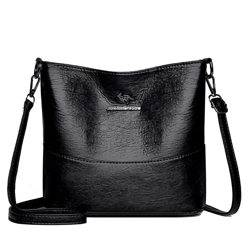 Women's soft leather bucket shoulder bag in black, shown with minimalist design and sewing line detail.