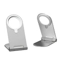 Silver vertical adjustable magnetic phone bracket for iPhone 12 on a table.