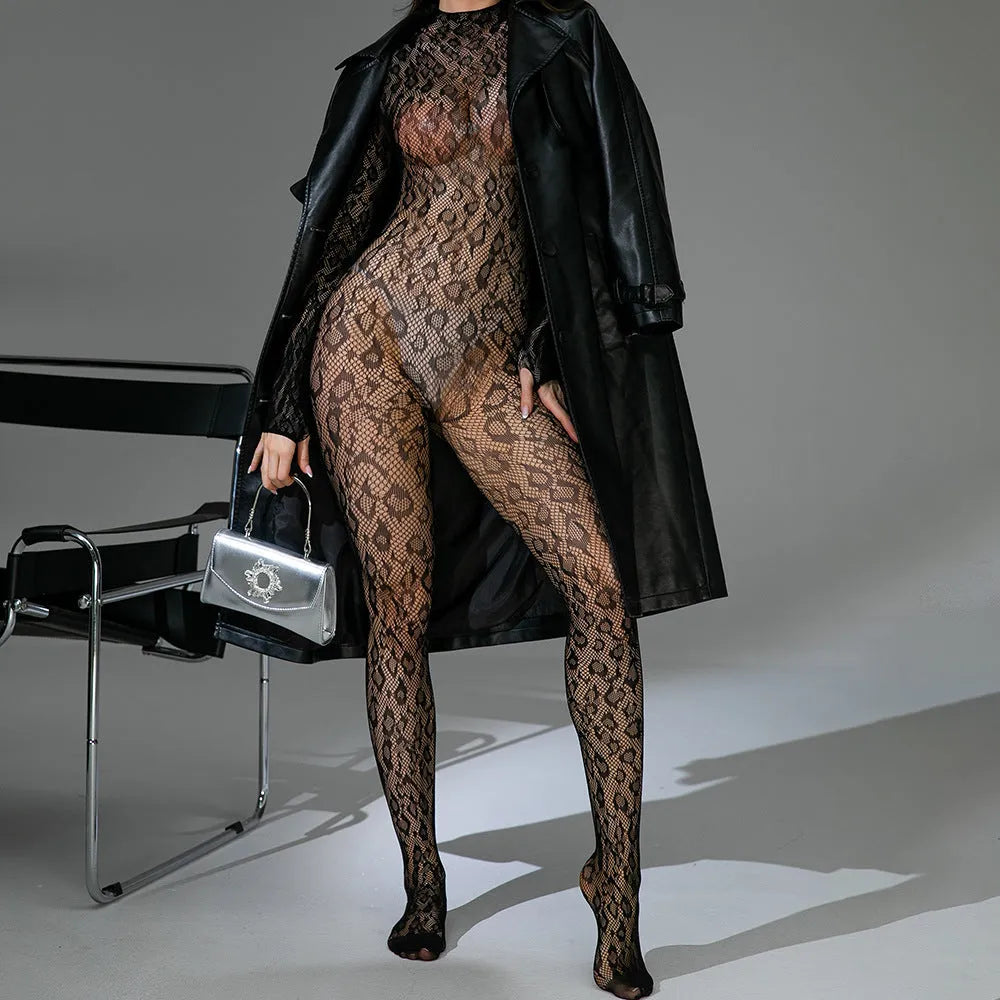 Women's black long sleeve backless lingerie one-piece in jacquard fishnet fabric on a mannequin.