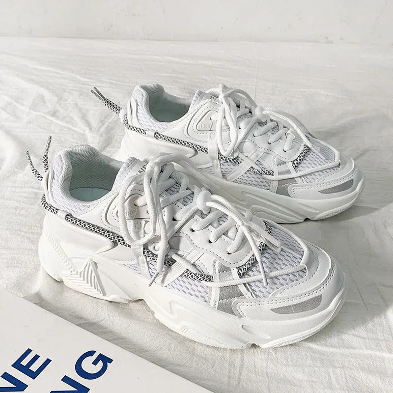 Men's white platform dad sneakers with a lace-up front and thick sole, shown on a grey background.