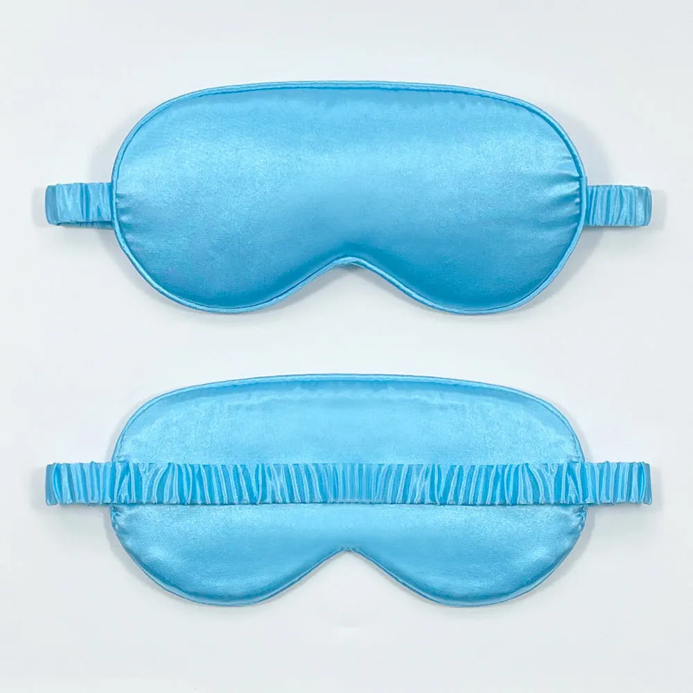 Reversible silk-like sleep eyeshade shown in multiple colour options including sky blue, wine red, and black.