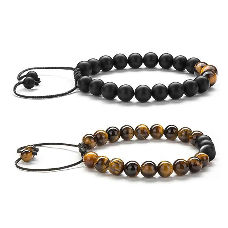 A pair of matte black agate bead bracelets with geometric design for him and her.